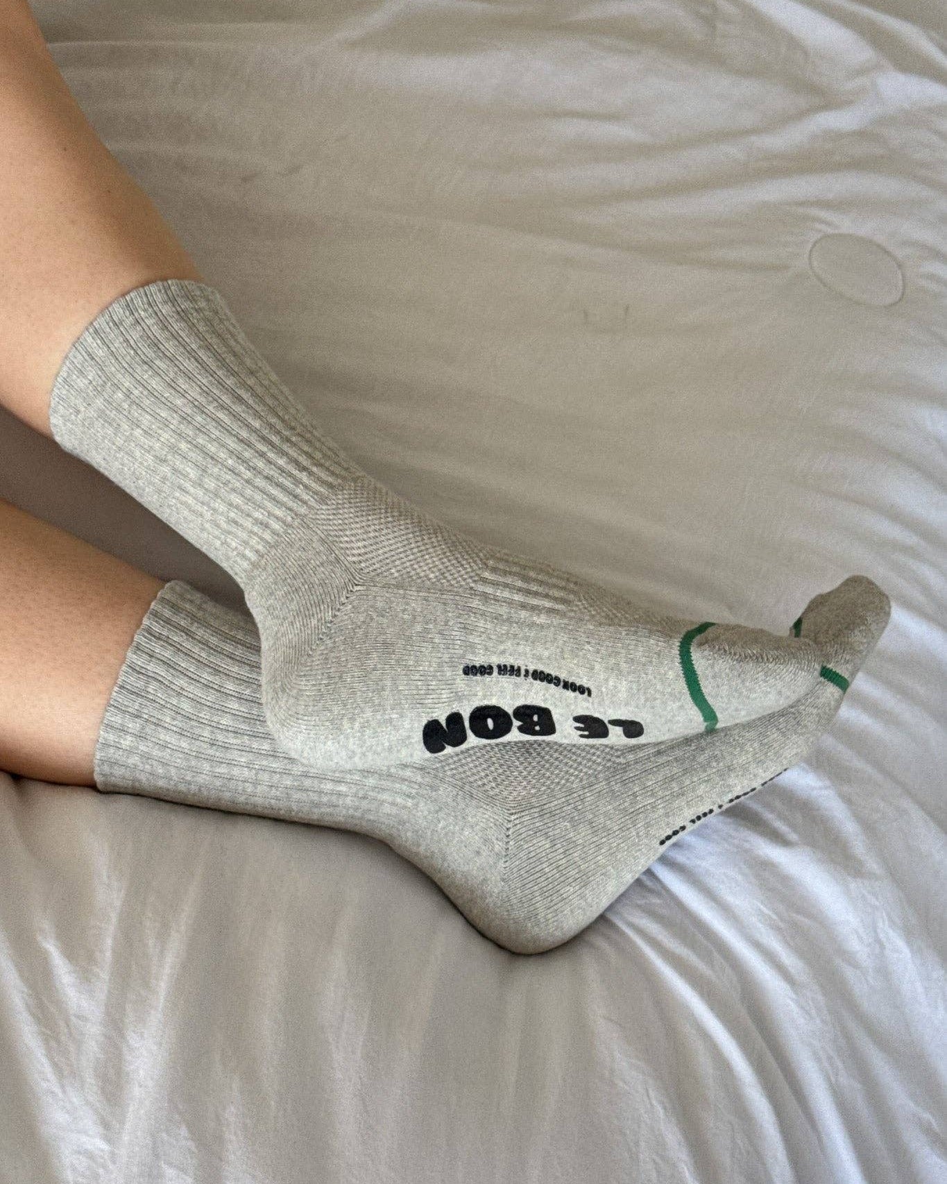 Gray socks with text on a light-colored surface
