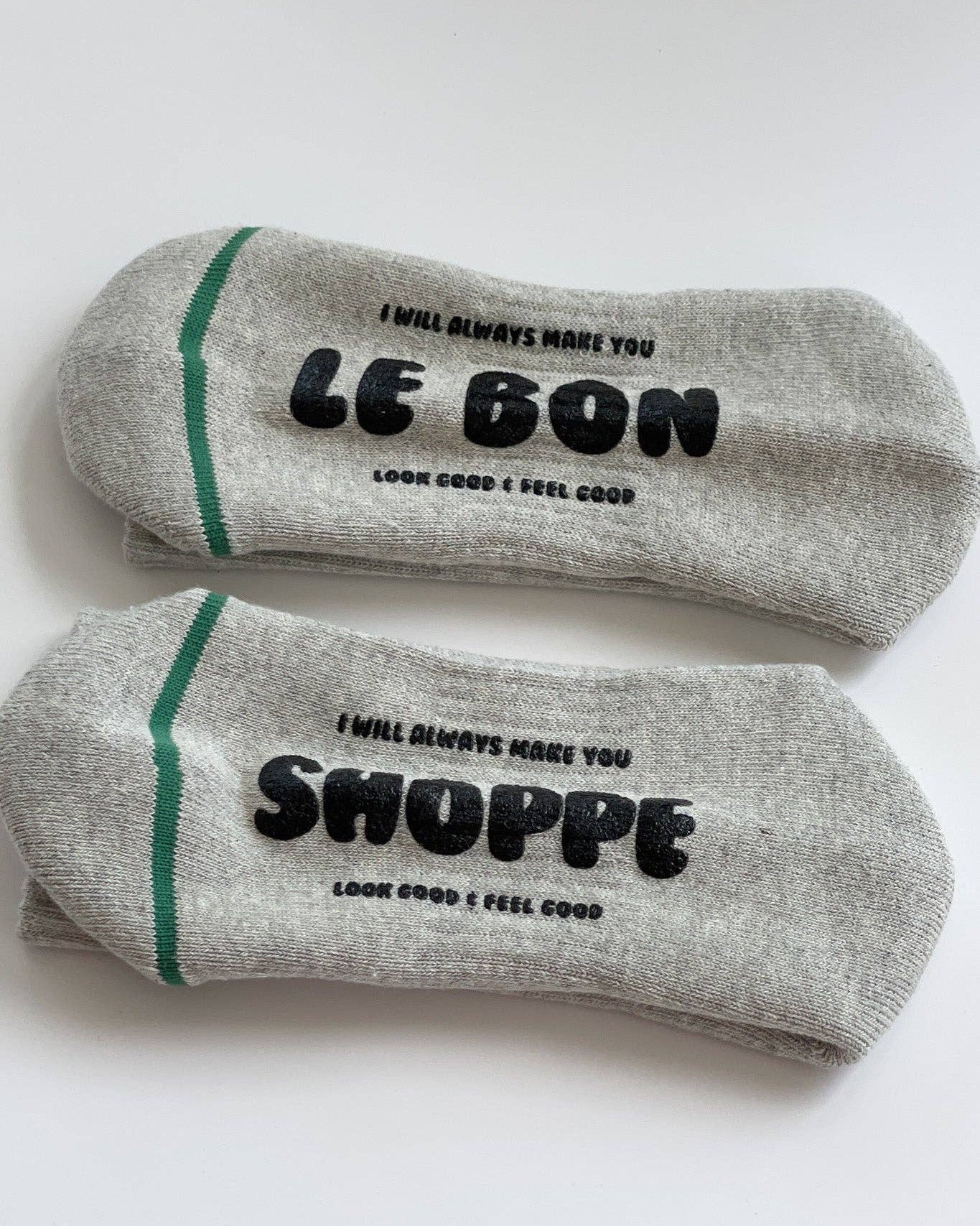 Two gray socks with text on a white background