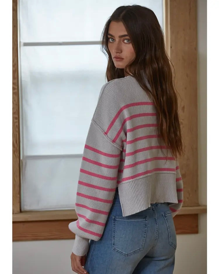 Model wearing By Together Pink/gray Striped Crop Sweater wearing jeans standing in front of window