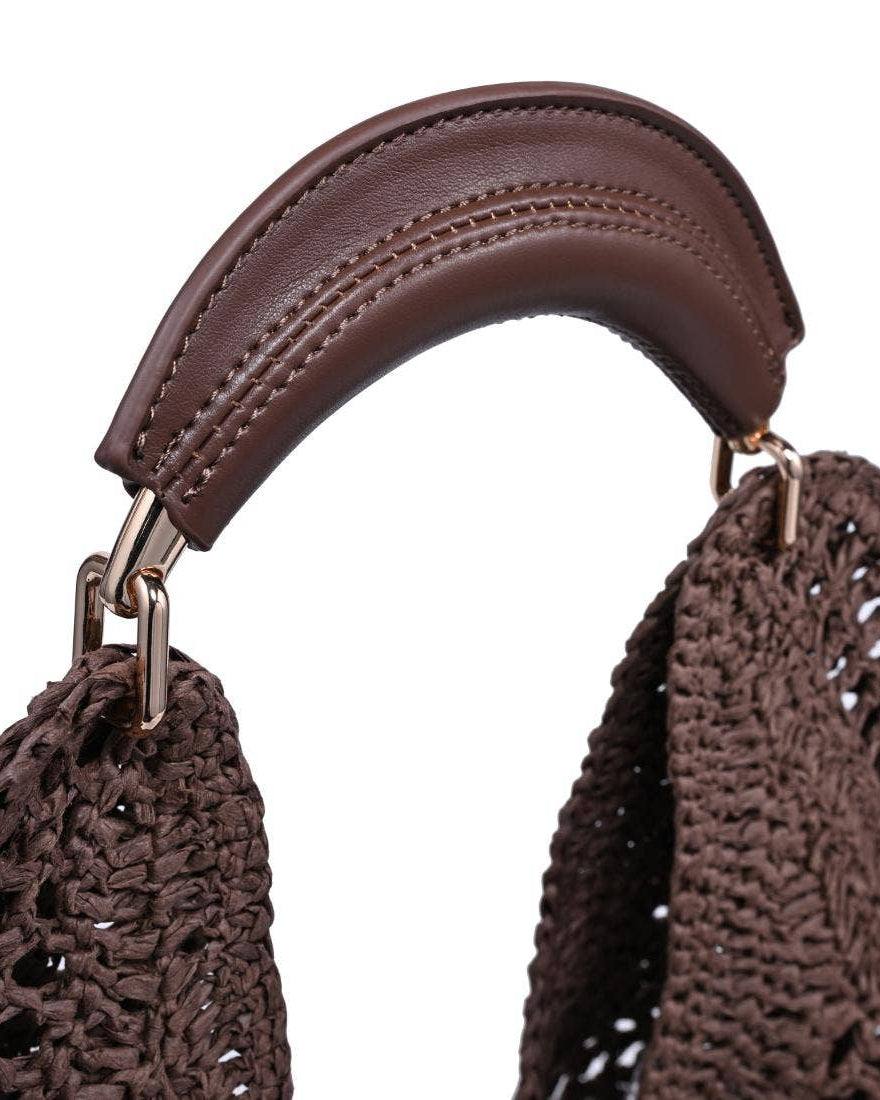 Brown woven handbag with a leather handle on a white background