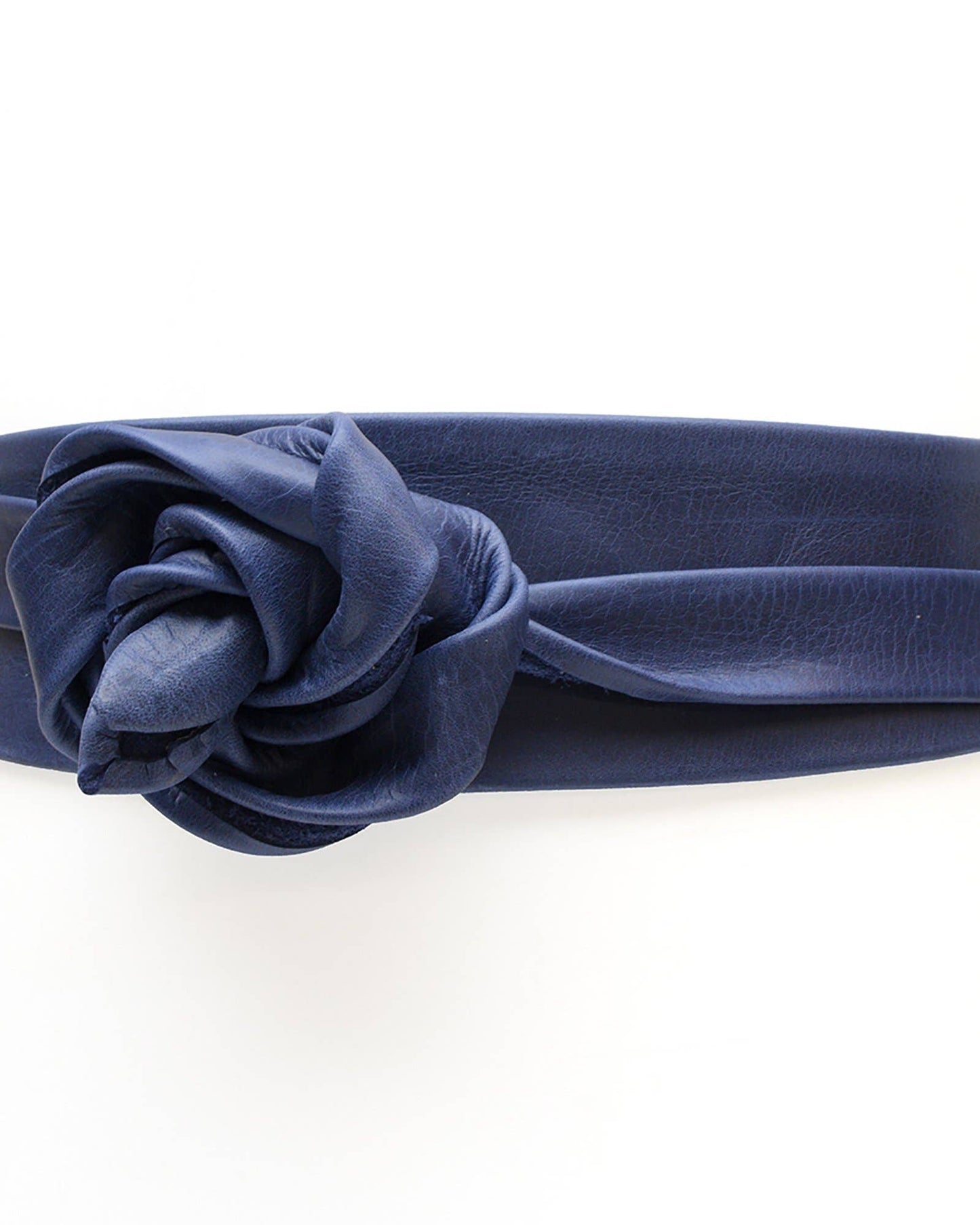 Navy blue belt with a flower accessory on a white background