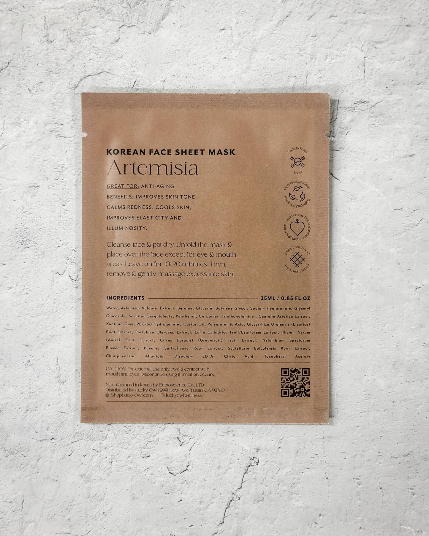 Korean face sheet mask packaging with text and QR code on a textured gray background