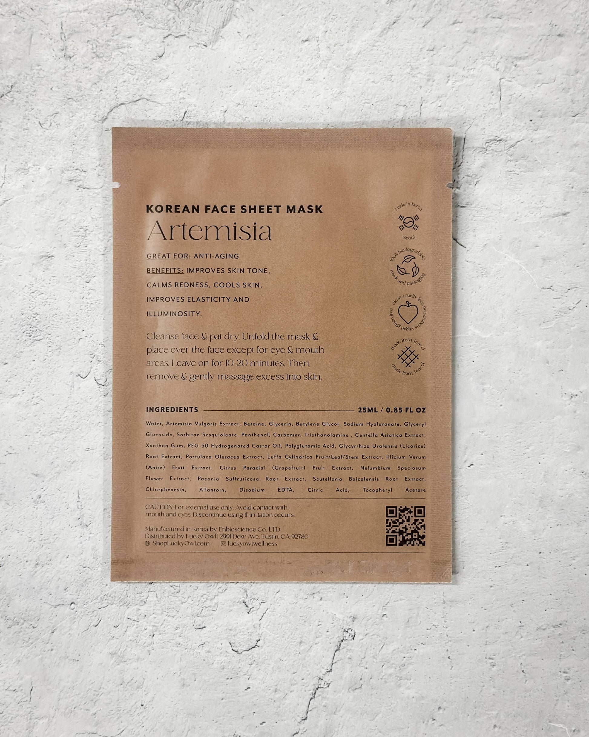 Korean face sheet mask packaging with text and QR code on a textured gray background