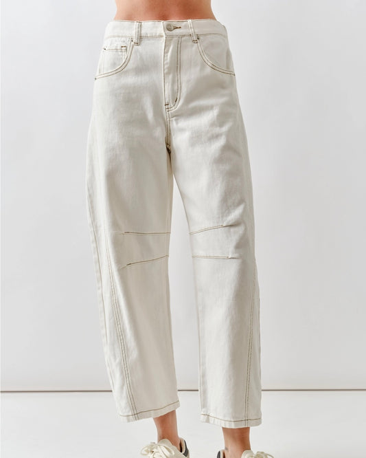 Model is wearing Aaron and Amber Crop Barrel Jeans in color cream on white background