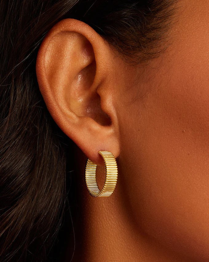 Image of models ear wearing Gorjana Catalina gold hoop earrings 