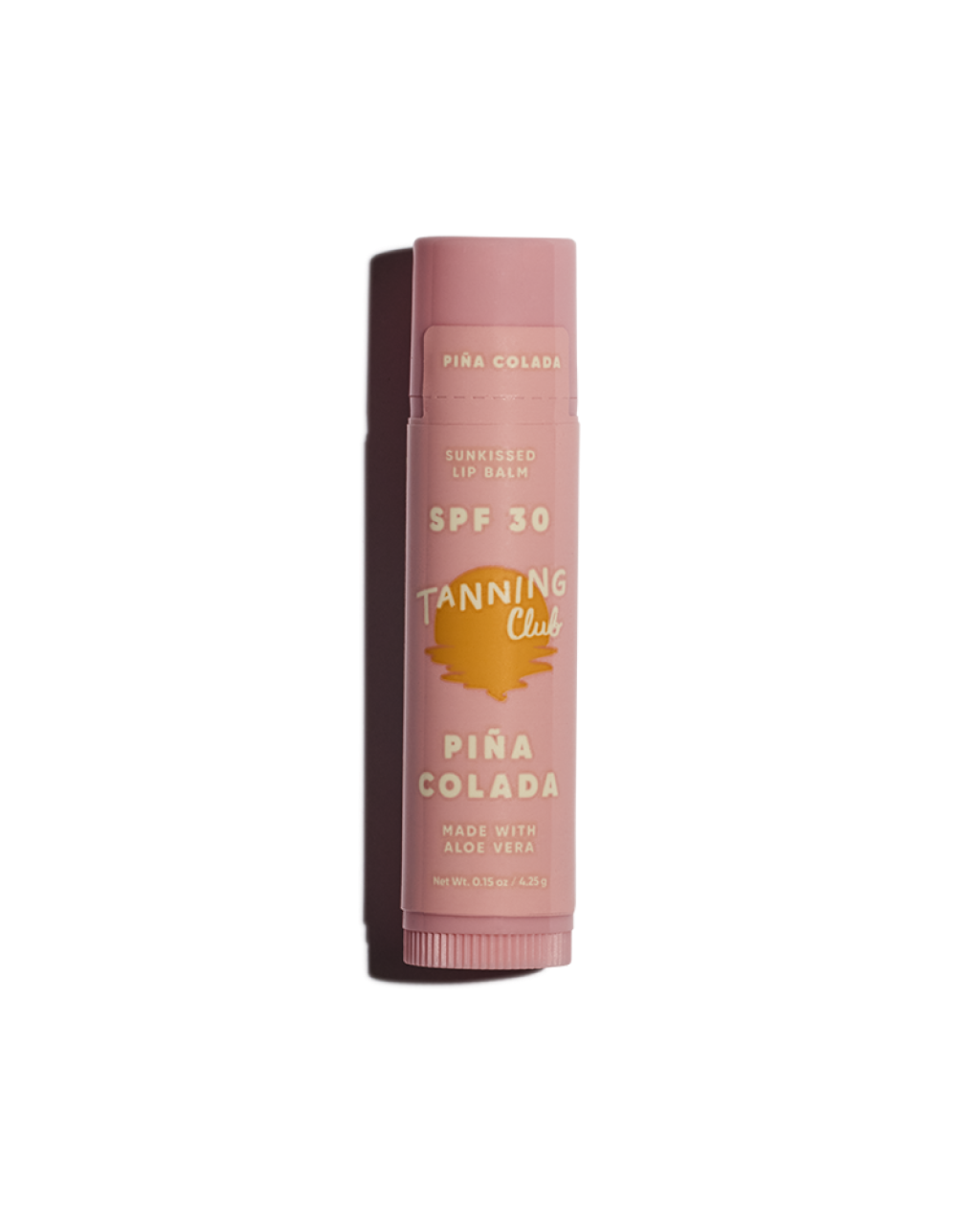 Pink lip balm with 'Tanning Club' branding on a white background