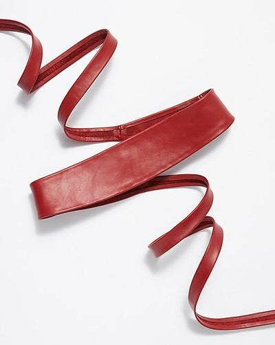 Red leather belt on a white background