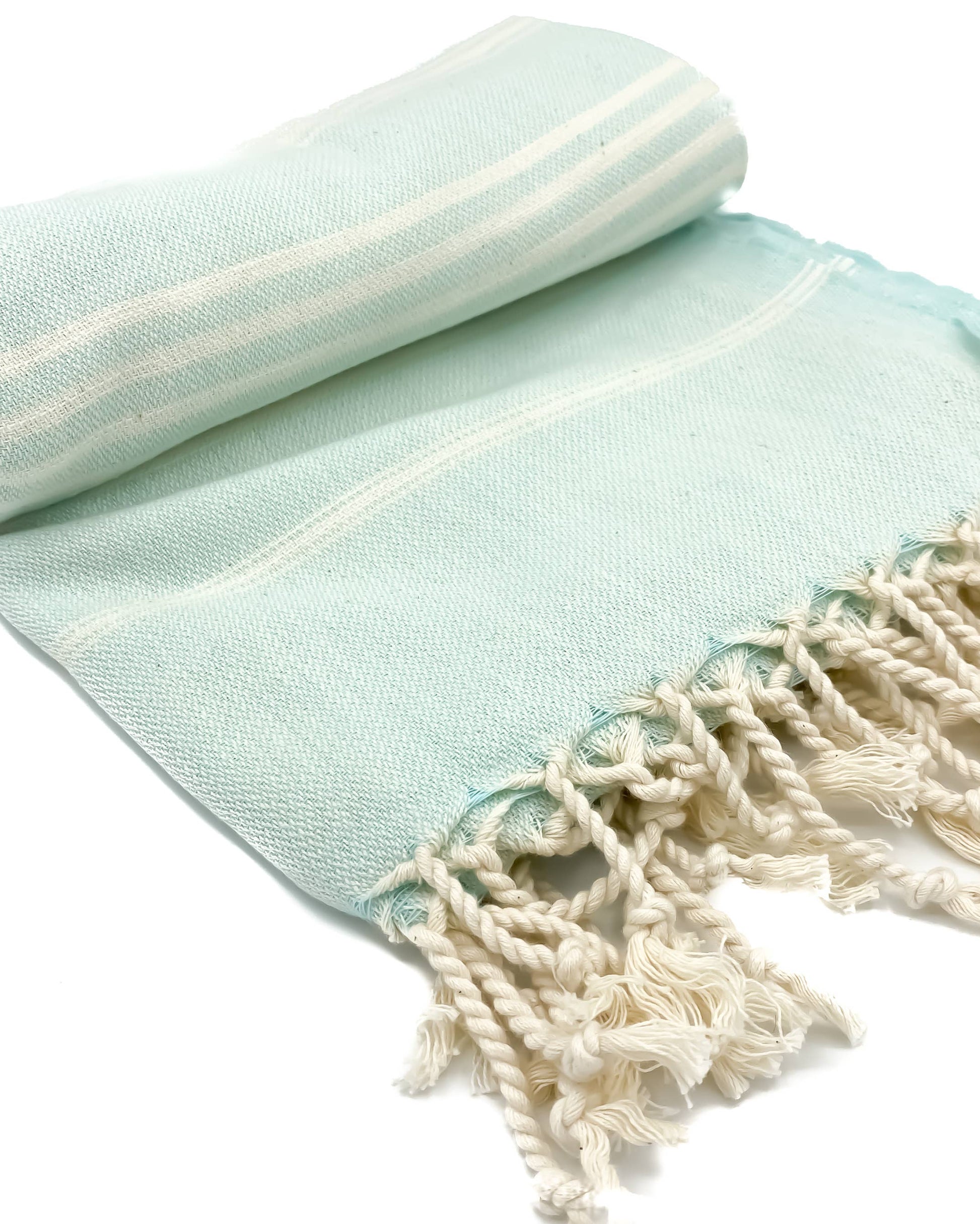 Light blue towel with white fringes on a white background