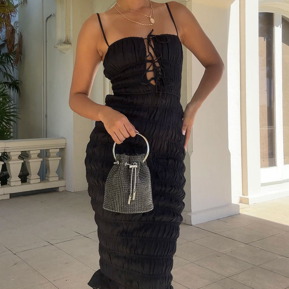 Model holding Melie Bianco kasee Crystal Top Handle bag wearing a black dress
