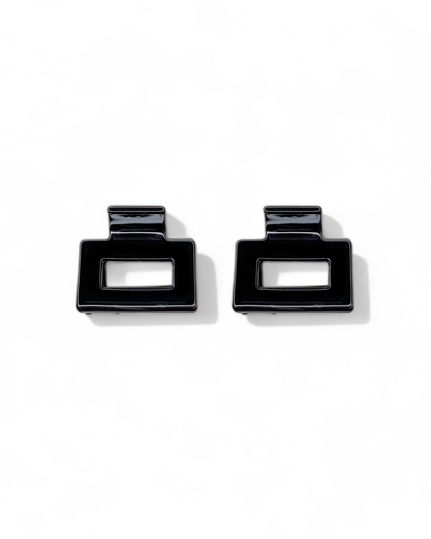 Pair of black square earrings on a white background
