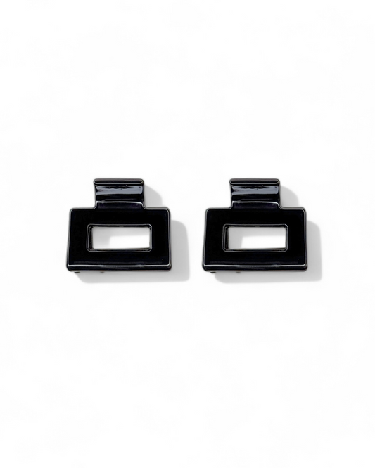 Pair of black square earrings on a white background