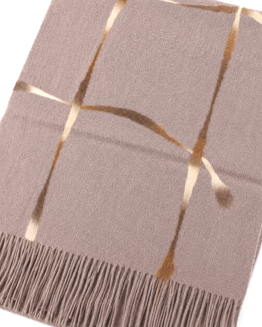 A close-up of a woven throw blanket in a muted taupe-brown color with metallic gold geometric stripe patterns and a fringed edge, shown on a plain white background.