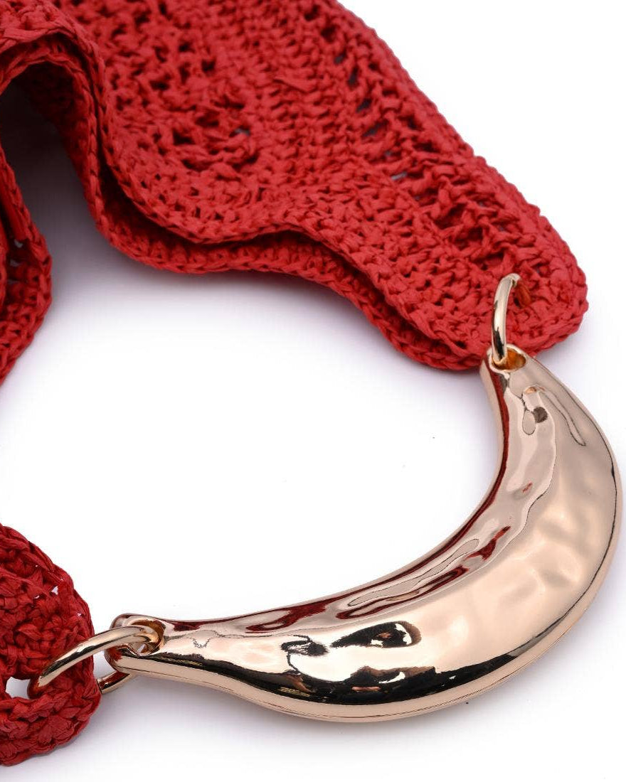 Red knitted scarf with a gold hook on a white background