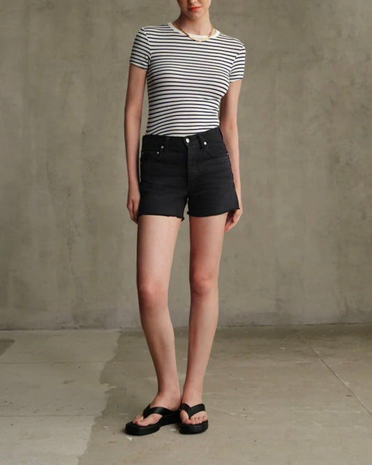 Model is wearing Edwin Sawyer Boyfriend Short in Carbon Black on a grey background. 