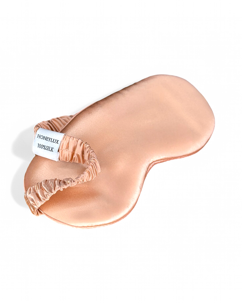 Pink HoneyLux silk sleep mask on a white background