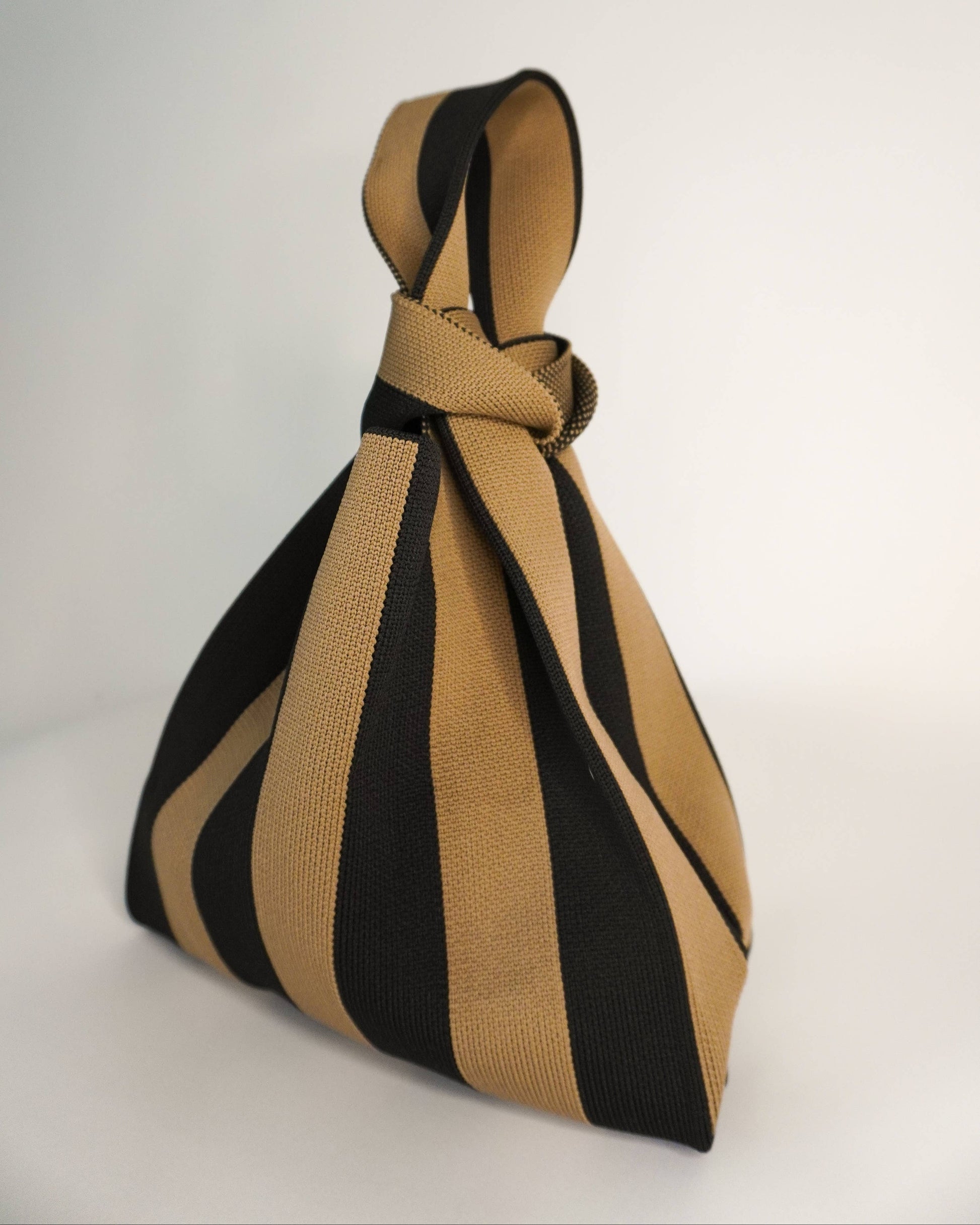 Black and beige striped bag on a white background