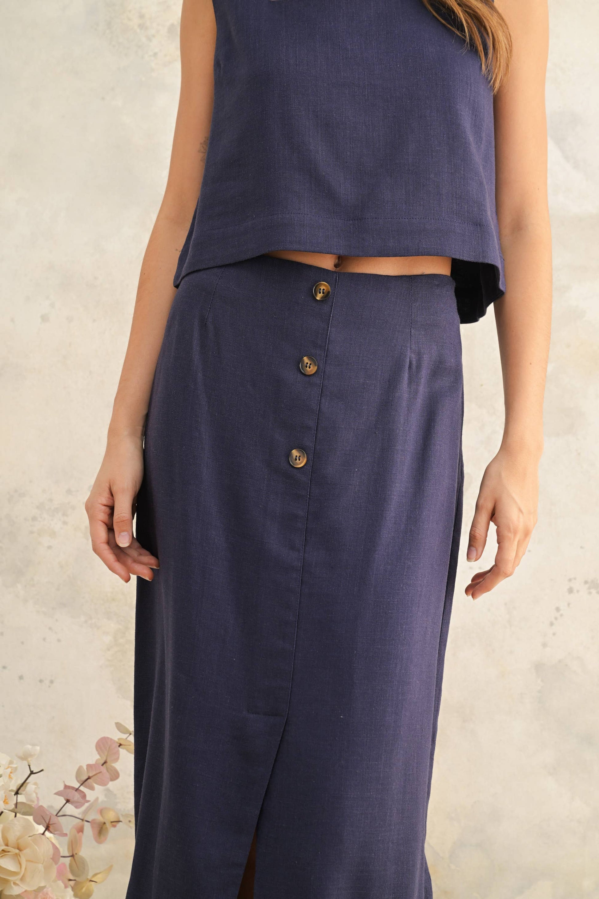 Navy blue sleeveless top and skirt set on a neutral background