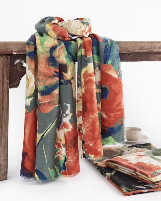 Colorful floral-patterned scarf draped over a wooden bench with a white background