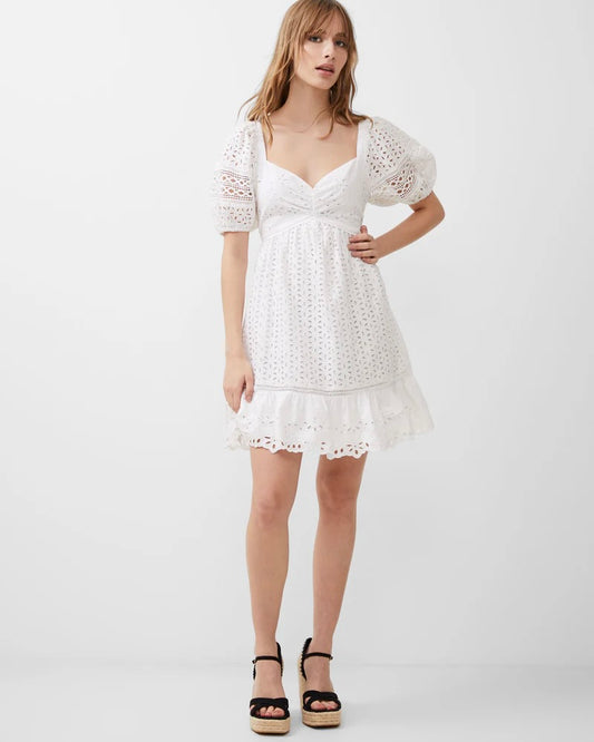 Model wearing French Connection Alissa Cotton Broderie Lace Dress wearing black sandals on a white Background
