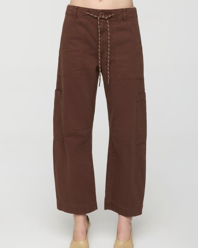 Brown pants worn by a person on a white background