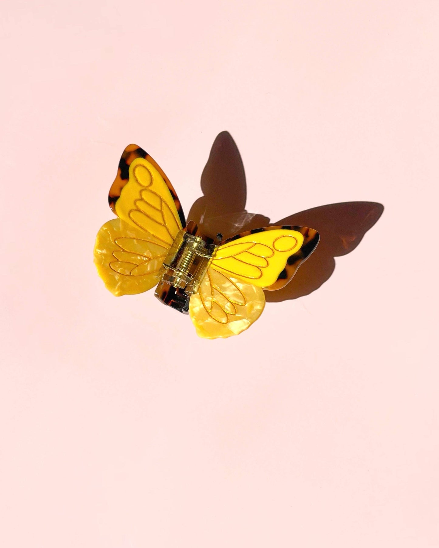 Butterfly-shaped object on a pink background