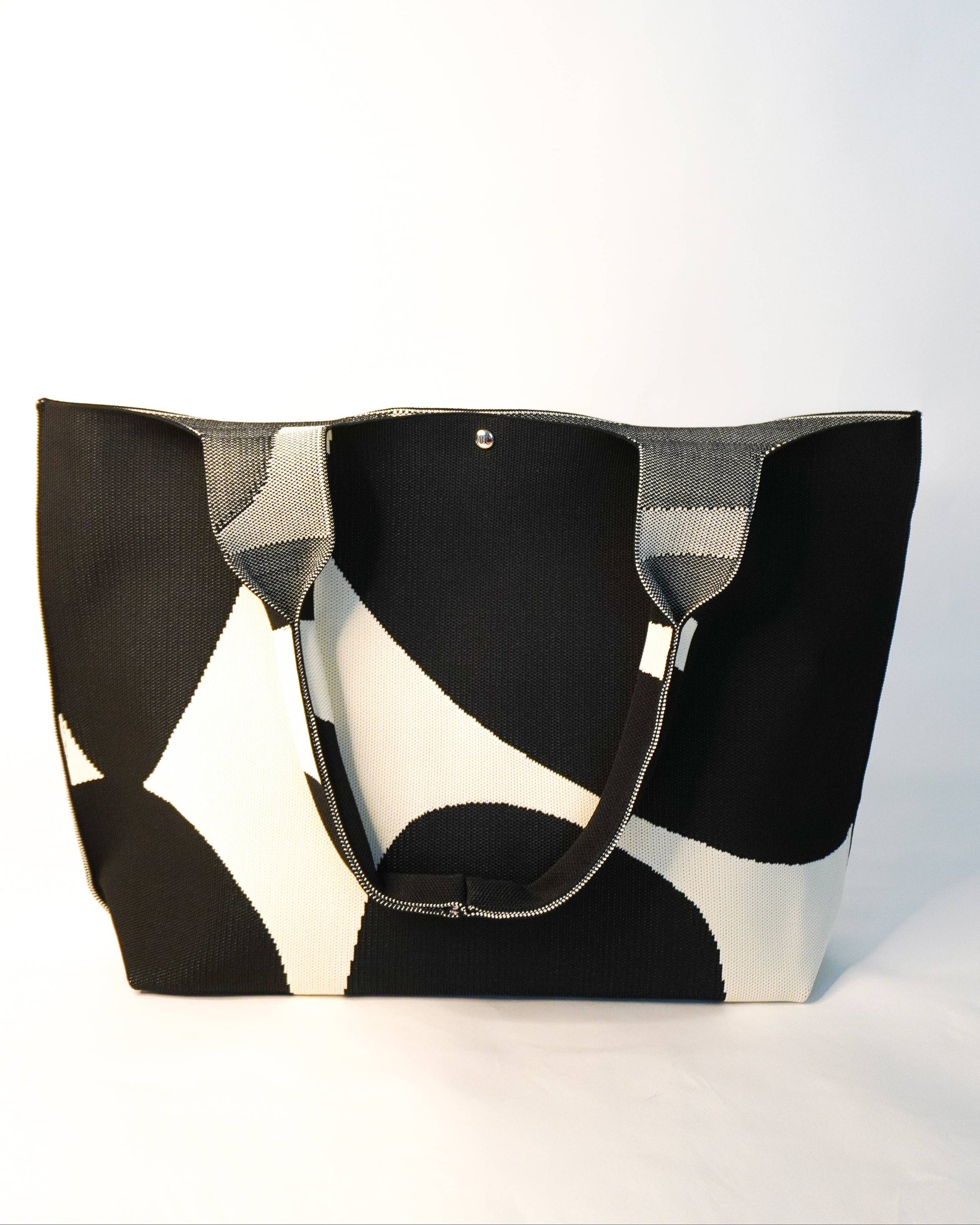 Black and white patterned tote bag on a light gray background