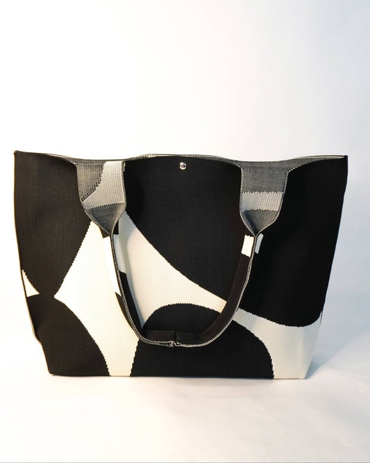 Black and white patterned tote bag on a light gray background