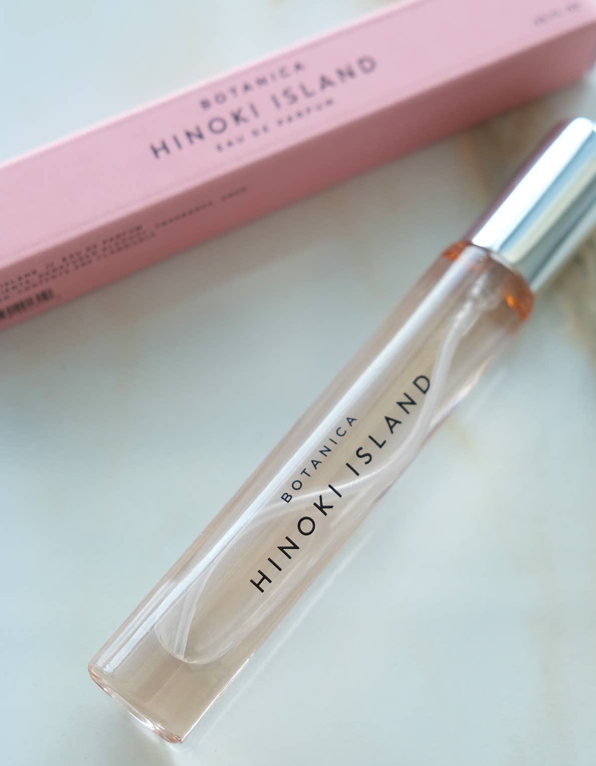 Botanica Hinoki Island perfume bottle and packaging on a light background