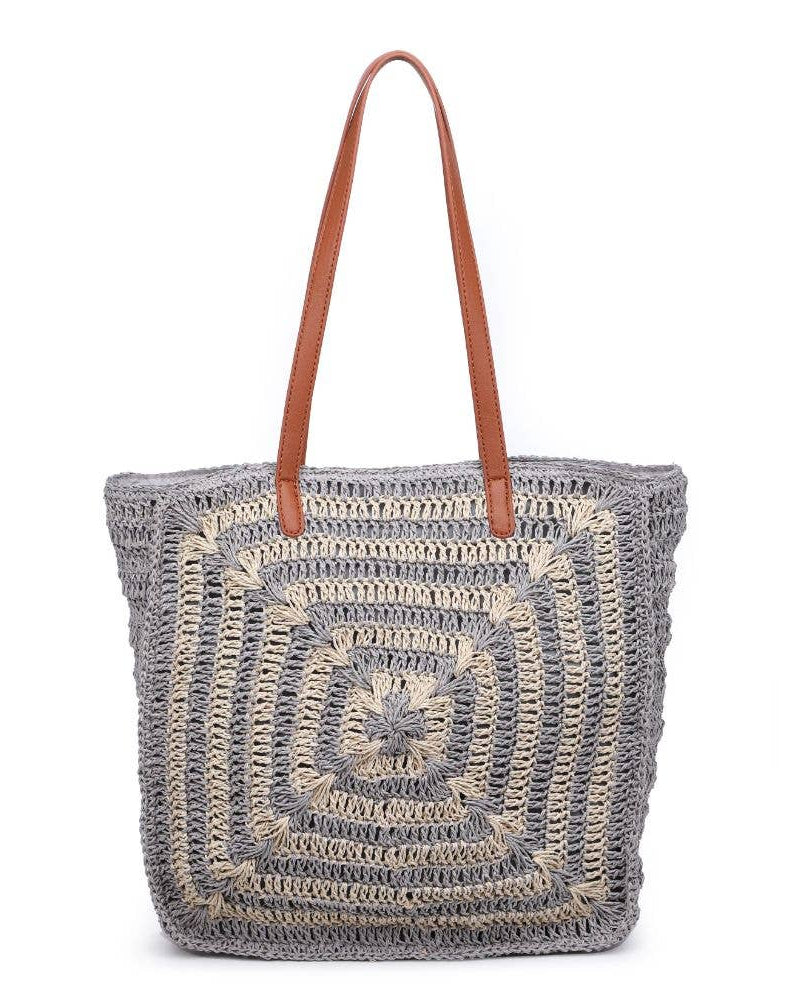 Crocheted tote bag with a brown handle on a white background