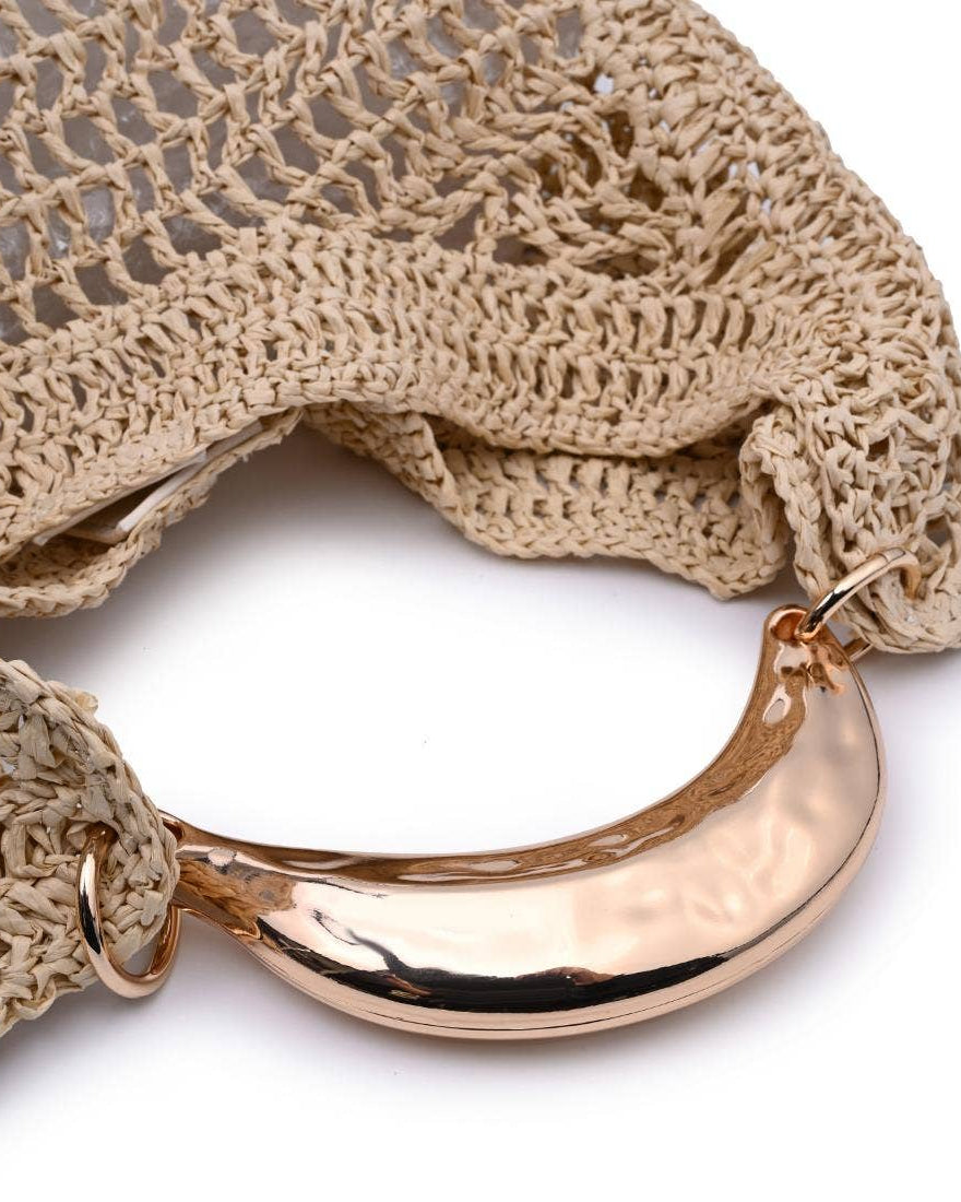 Close-up of a beige crochet bag with a rose gold metal clasp on a white background