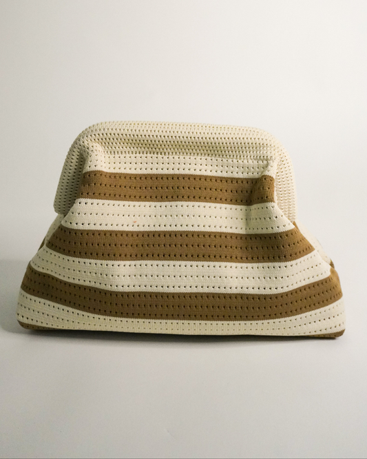 Crocheted clutch with brown and beige stripes on a light gray background