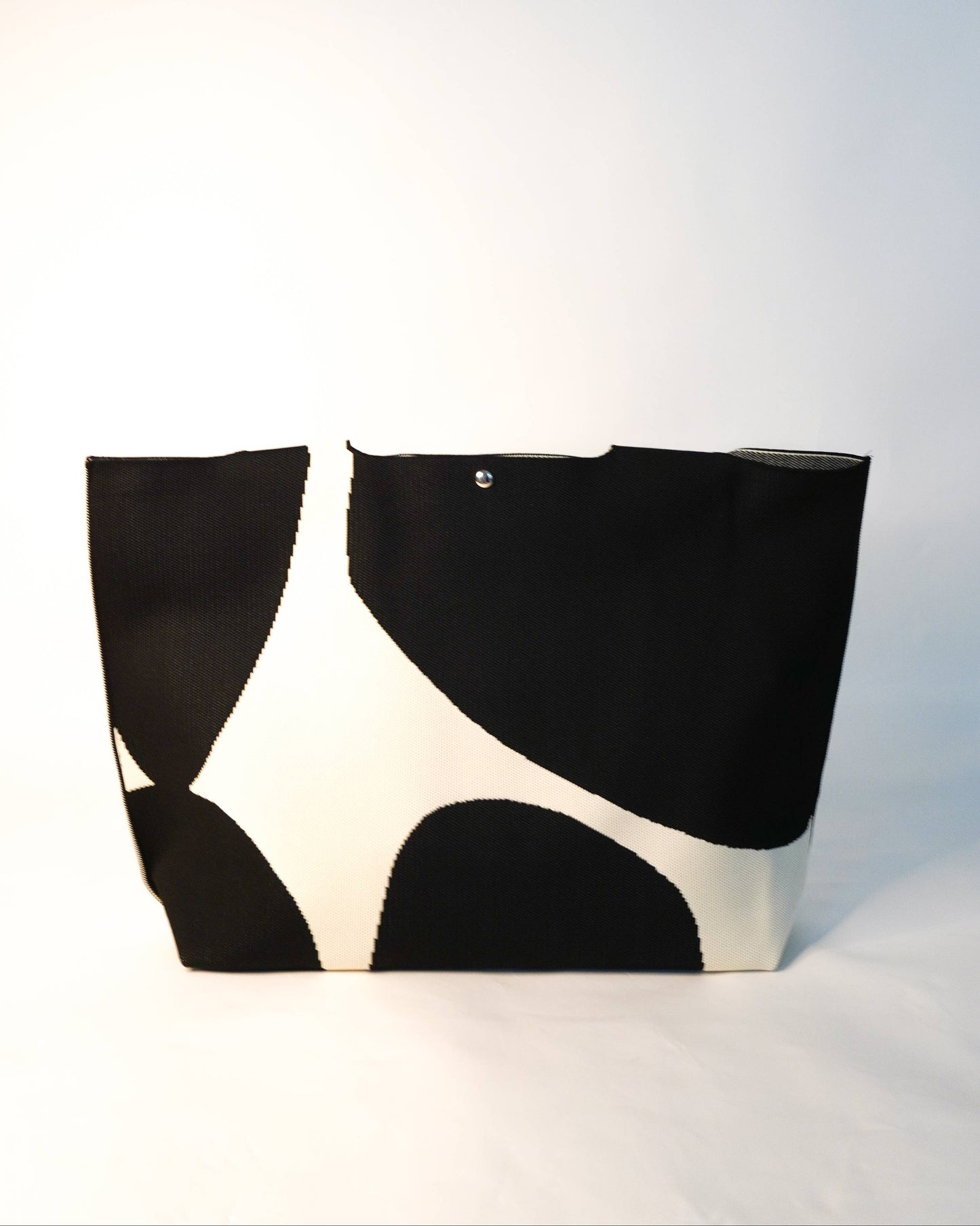 Black and white patterned bag on a light gray background