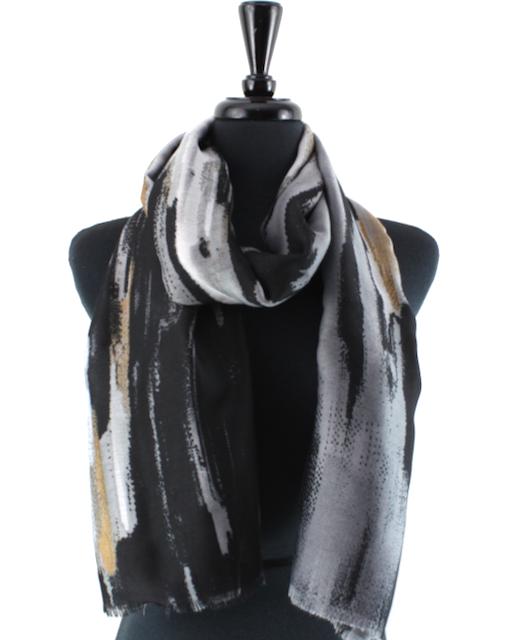 A lightweight scarf with an abstract brushstroke pattern in black, gray, white, and beige, draped on a black mannequin torso against a plain white background.