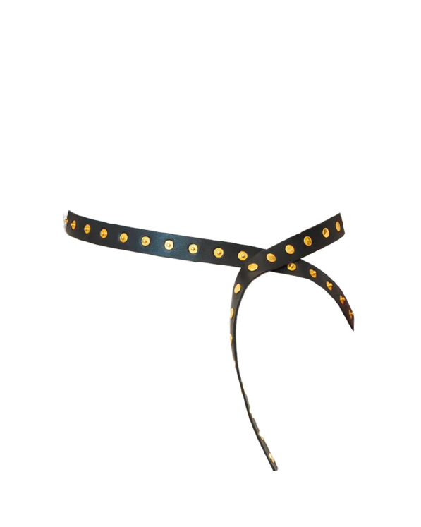 Black headband with gold polka dots on a white background