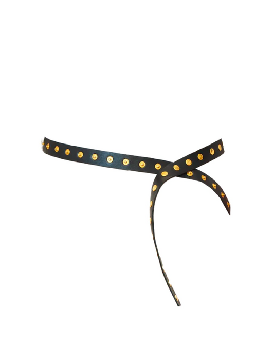 Black headband with gold polka dots on a white background