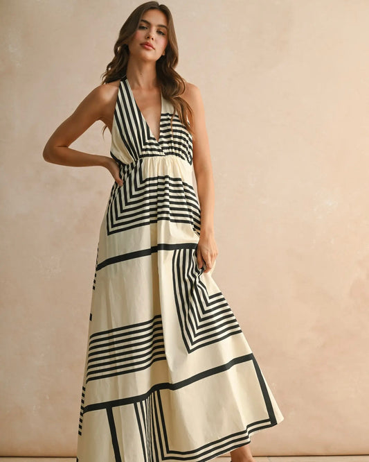 Woman wearing MIOU MUSE Geo Print Halter Dress against a beige background
