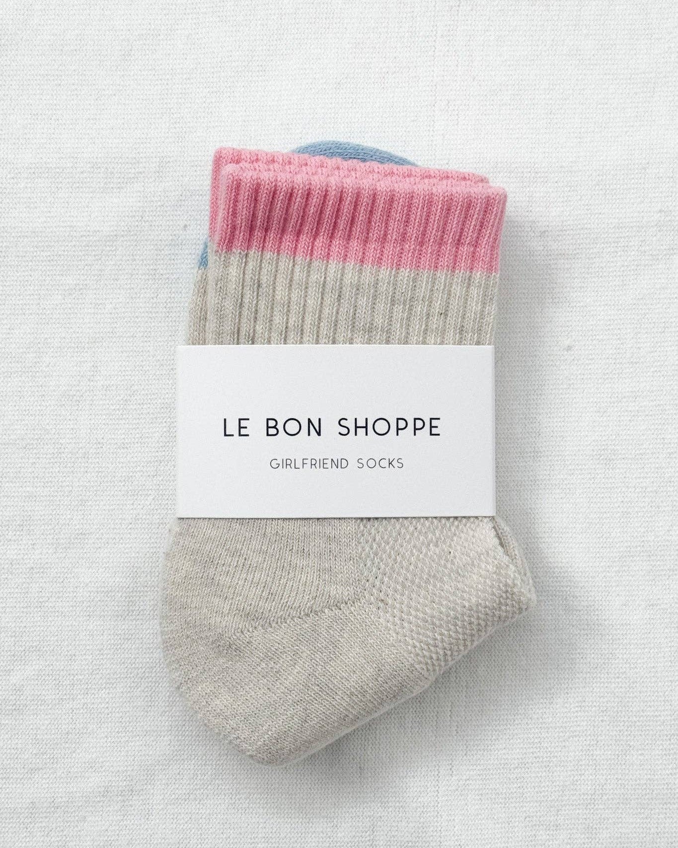 Pair of socks with pink and gray pattern on a white background, branded 'Le Bon Shoppe'.