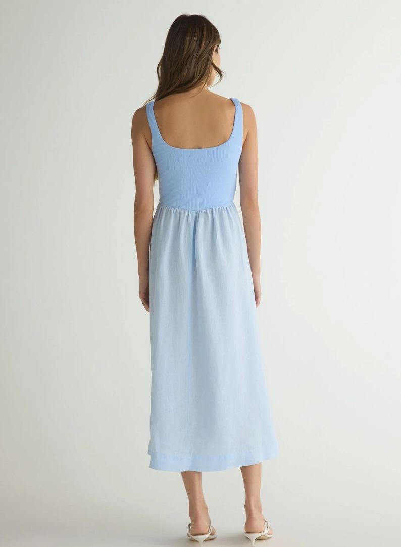 Model is wearing Bella Dahl Sleeveless Knit Combo Dress in Periwinkle blue with white sandals on a white background