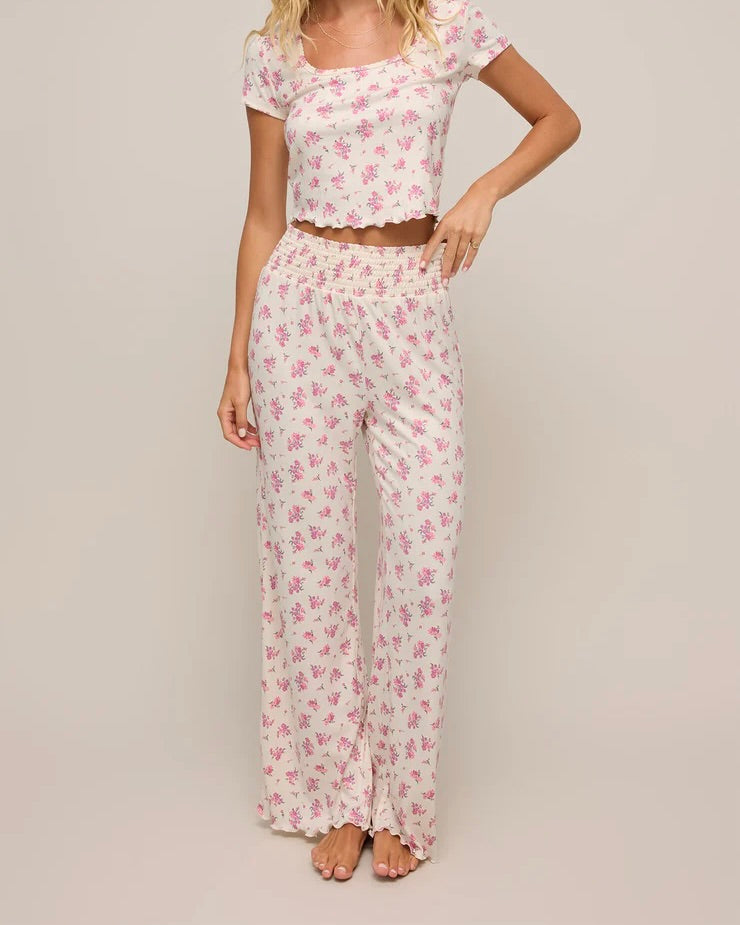 Model wearing the Z Supply Dawn Ditsy Pointelle Floral Pant with a matching tee standing barefoot in front of a white backdrop.