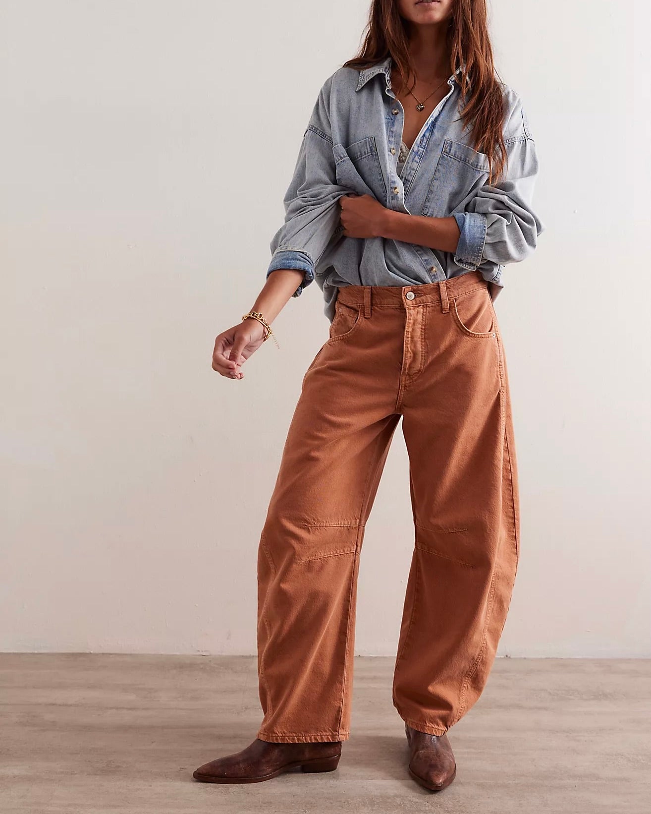 Model wearing Free People Good Luck Barrel Jeans In Ginger Root Color on a white background 