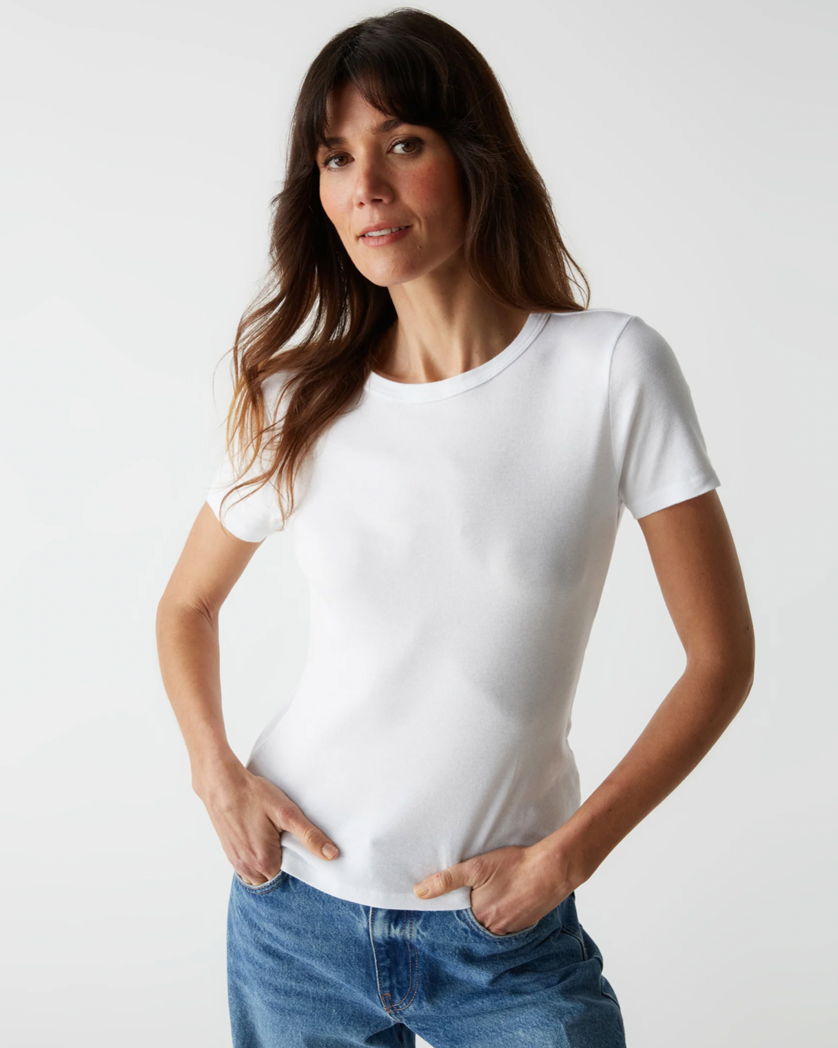 Model wearing Michael Stars Supima white mady crew neck tee wearing jeans on a white background