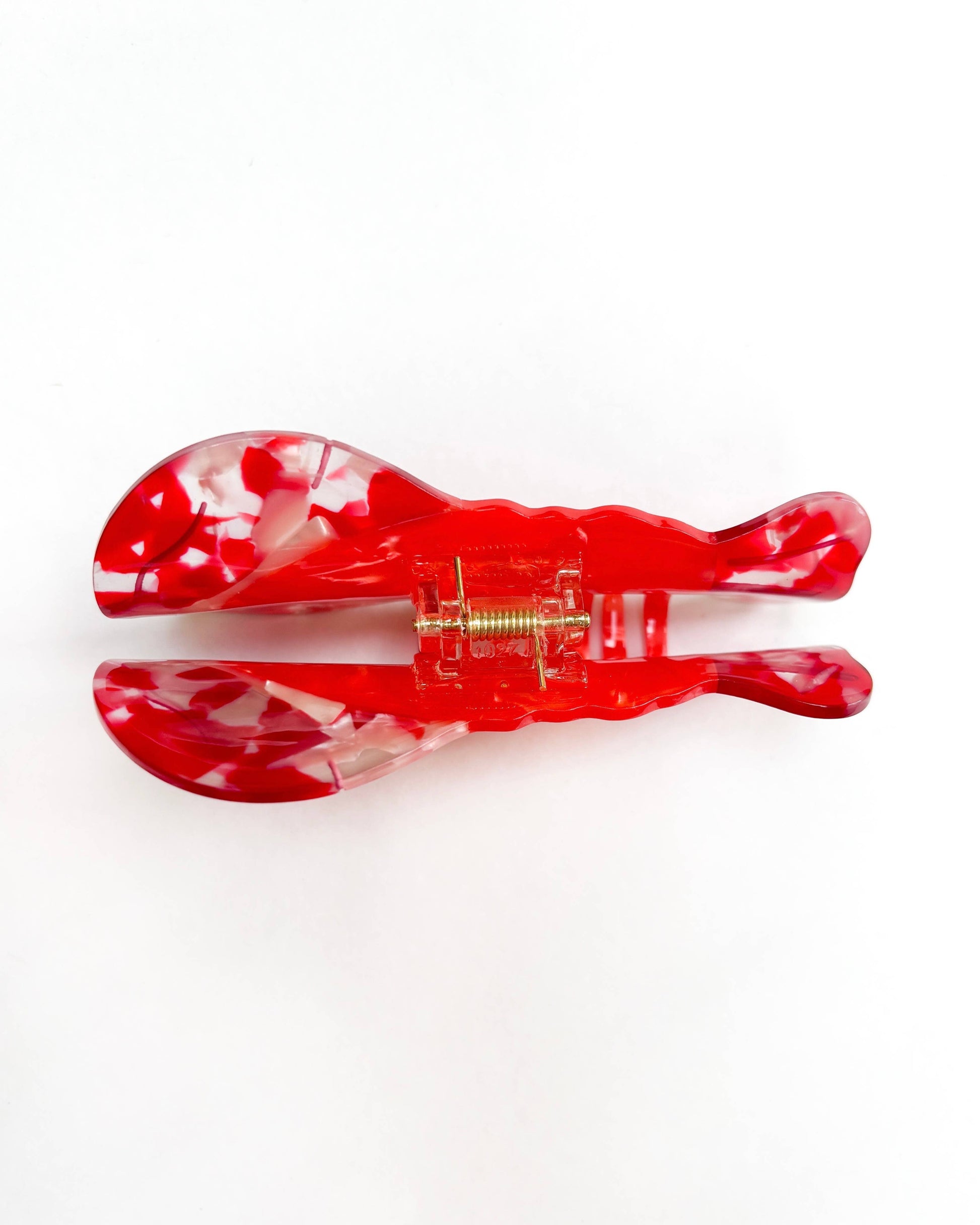 Back view of a red lobster hair clip on a white background