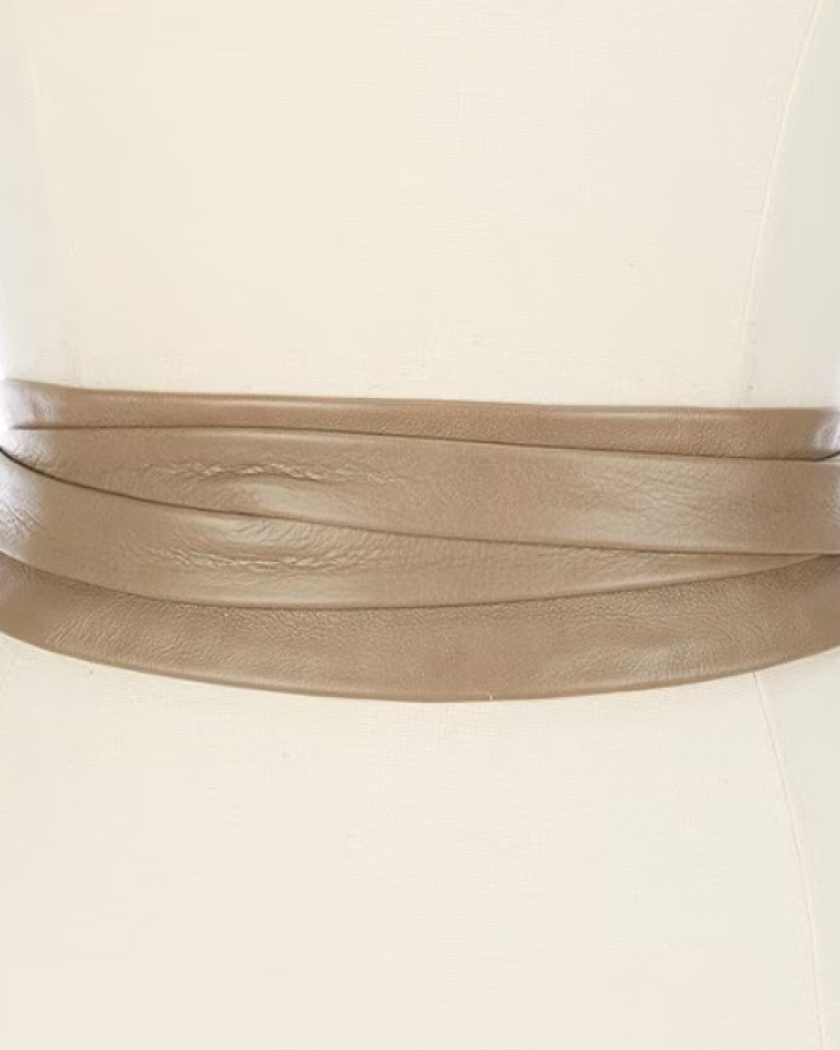 Mannequin wearing a beige dress with a wide leather belt.