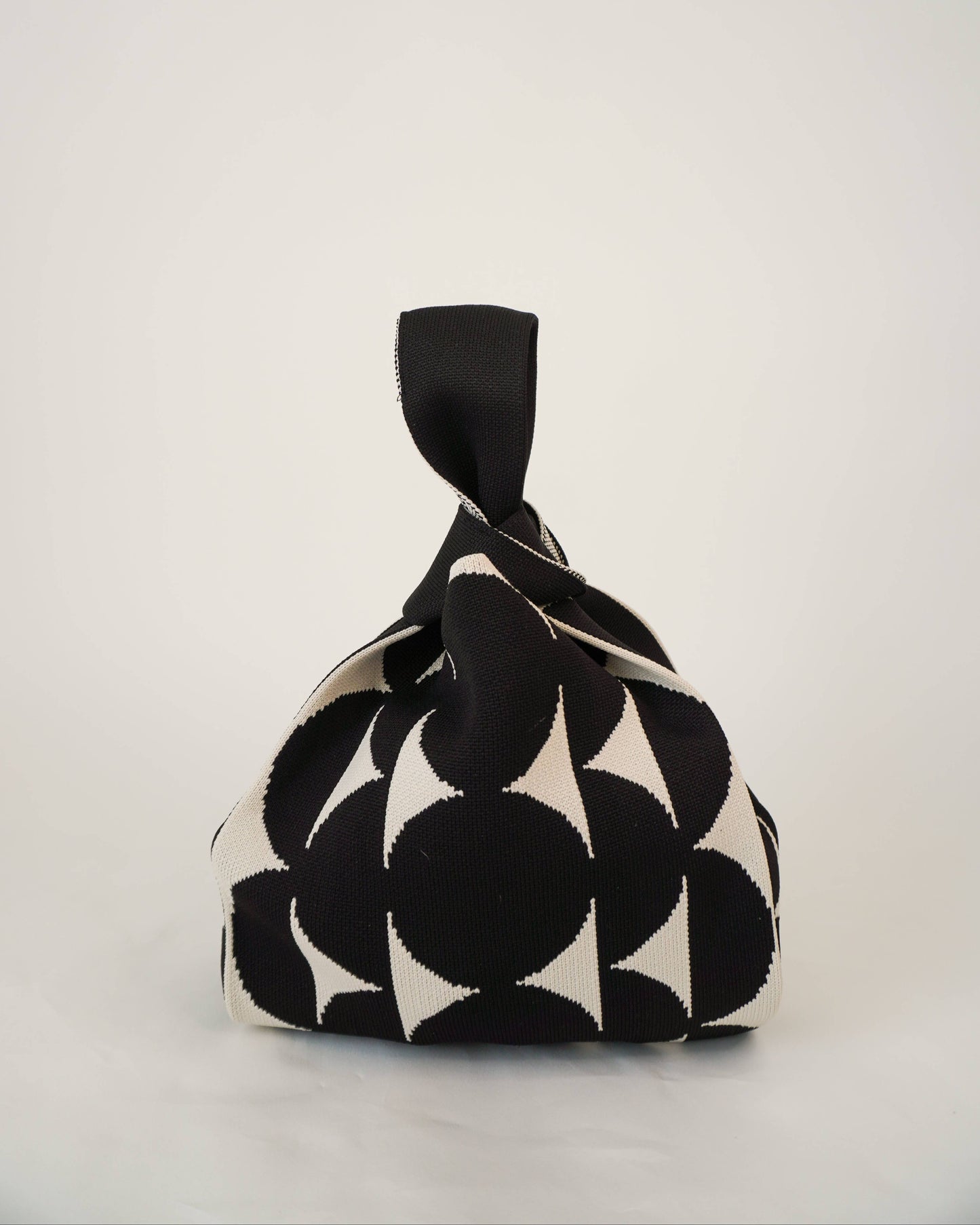 Black and white patterned fabric bag on a light gray background