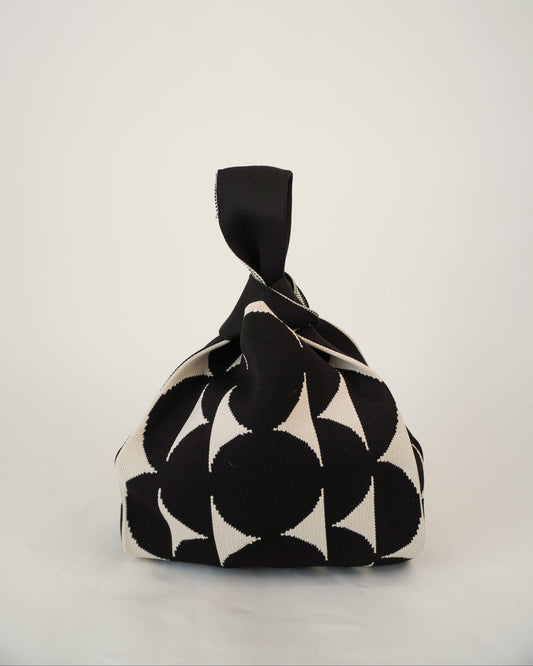 Black and white patterned fabric bag on a light gray background