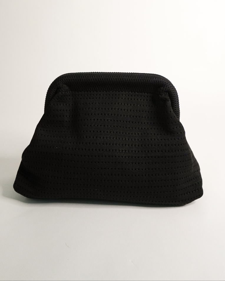 Black textured clutch bag on a light gray background
