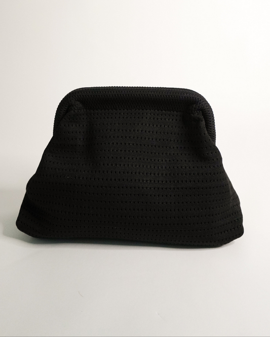 Black textured clutch bag on a light gray background