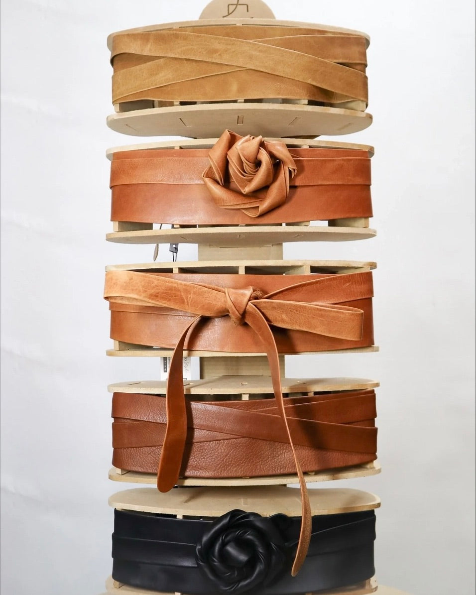 Ada wrap belts on display in various colors showing different ways to style them in front of a white background