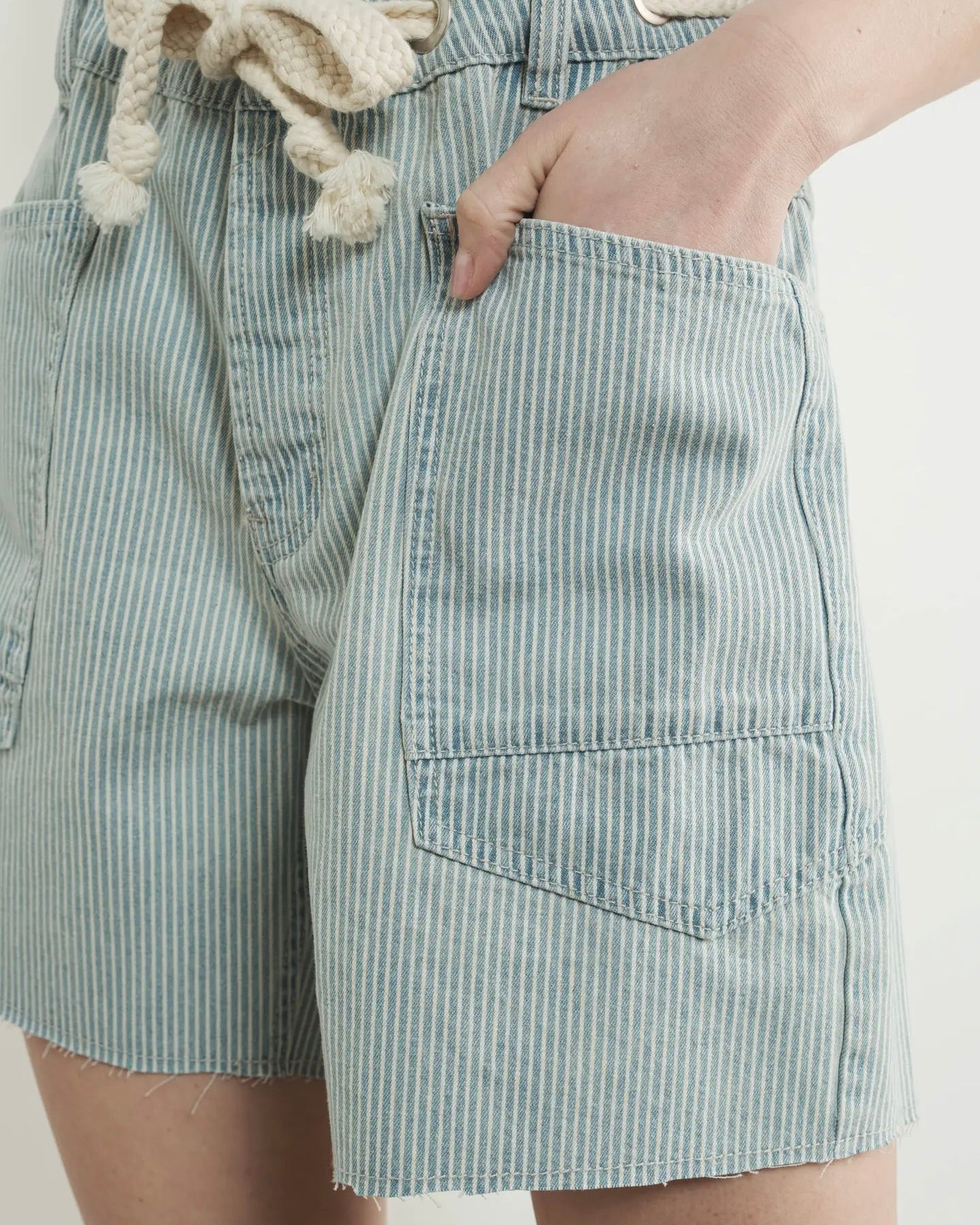 Model is wearing Aaron and Amber Vintage Washed Barrel Denim Shorts on a white background