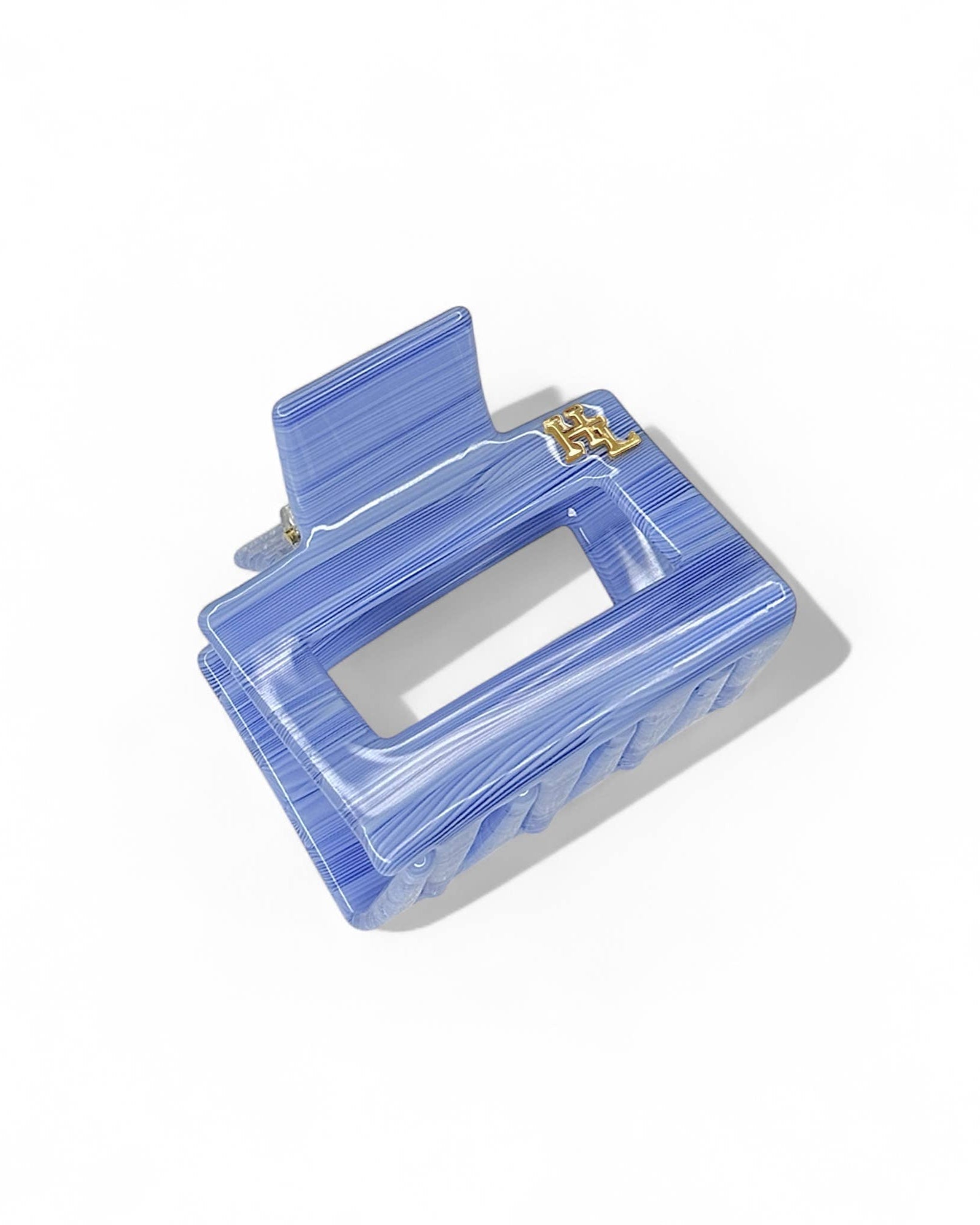 Top view of the HoneyLux Ecofriendly Acetate Midi Clip in the color Amalfi laying on a white background 